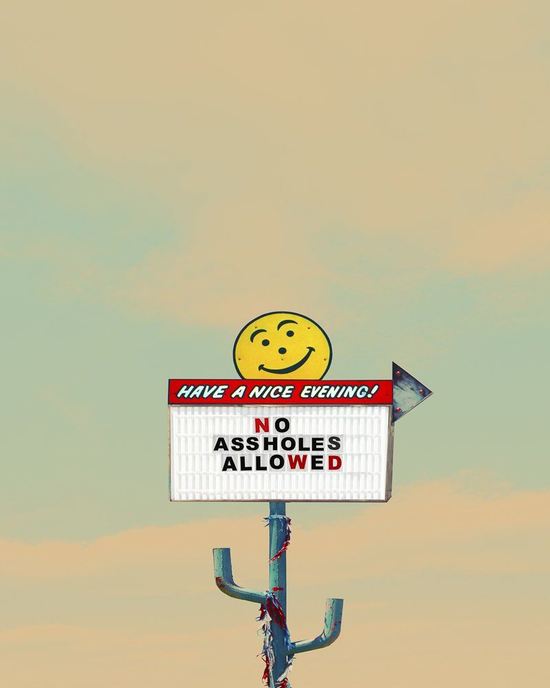 No Assholes Allowed sign Vintage-style roadside Americana print with bold message and smiling face illustration by Betsy Crum