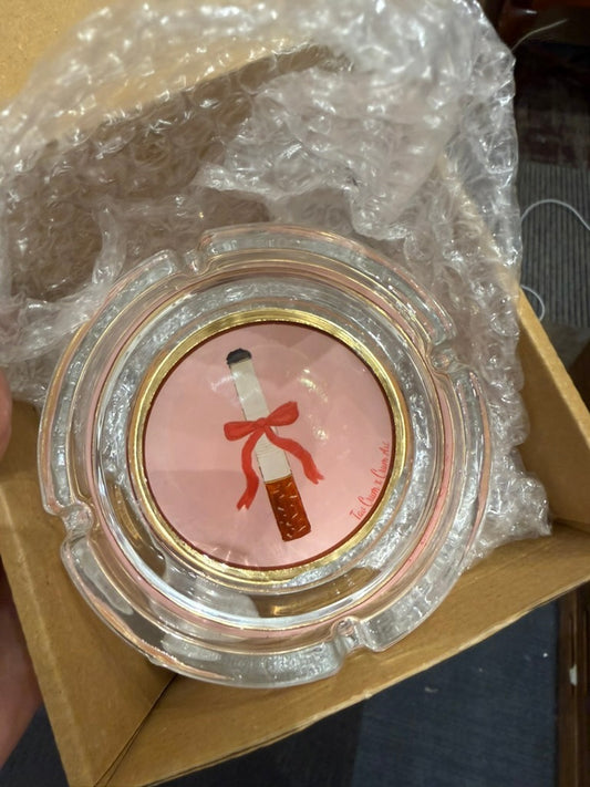 A single Cigarette with a Bow round glass ashtray by Tavi Crum, signed Tavi Crum x Crum Art