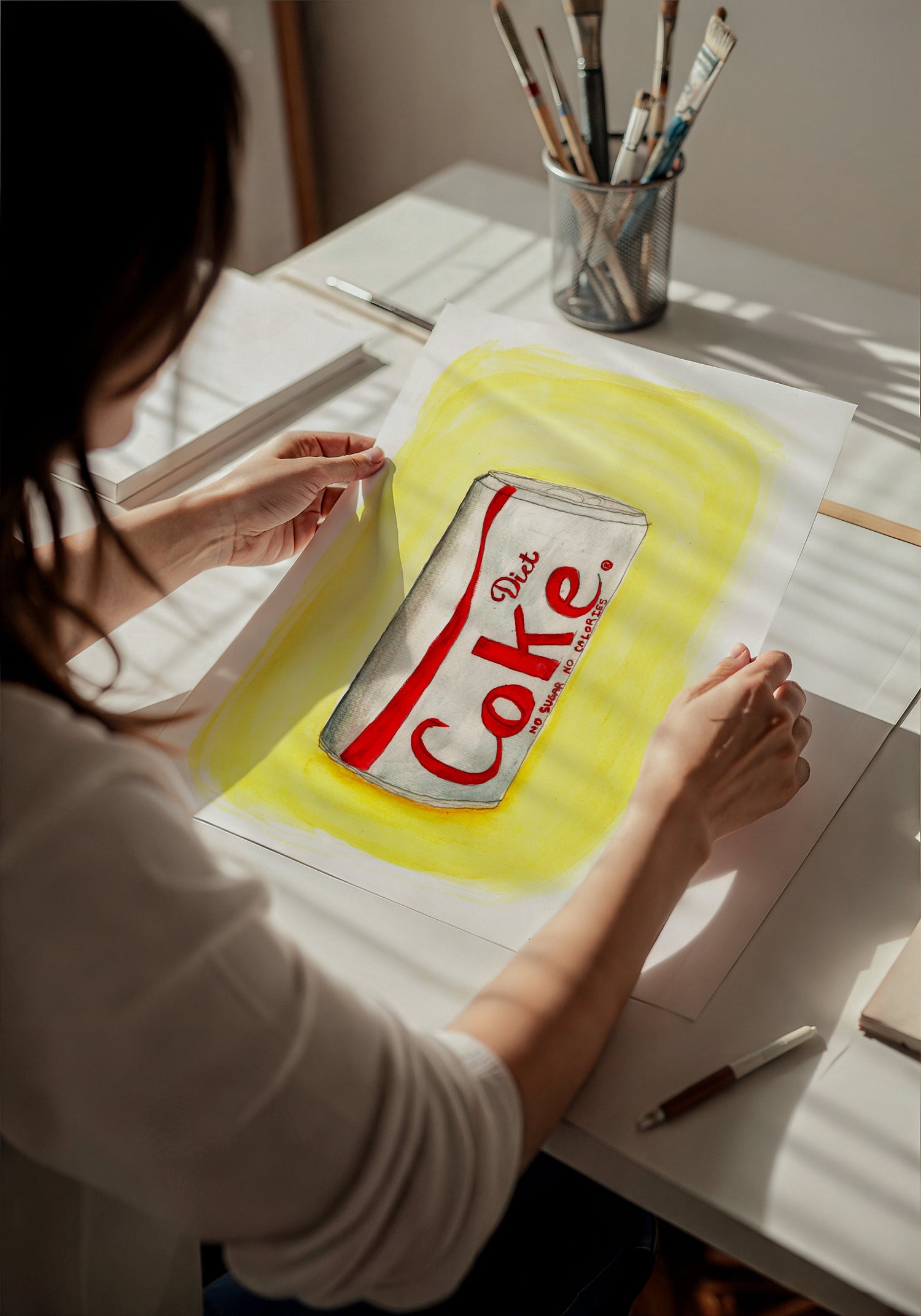 Hand-signed Diet Coke art print by Tavi Crum held in hands to show size