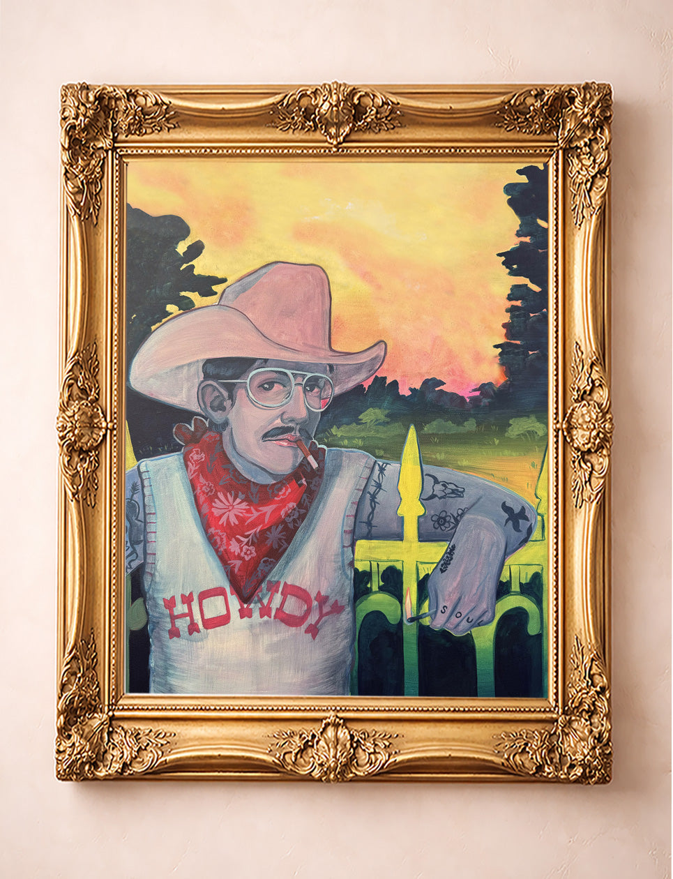 Howdy Rowdy cowboy art print by Caya Crum in a gold frame — mustached cowboy in a pink hat and HOWDY shirt leaning on an iron fence, cowboy gothic western wall decor