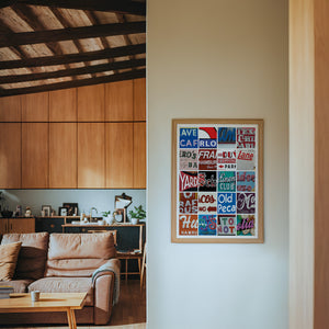 Alphabet of Austin Austin Art print by Betsy Crum — framed in a wood-accent room