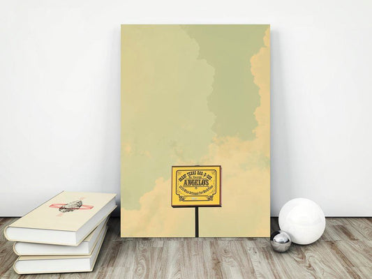 Angelos BBQ Art Print featuring vintage sign design on muted background displayed on wooden floor next to books and decorative spheres