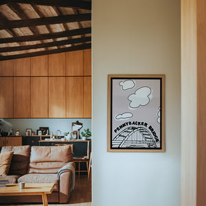 Pennybacker 360 Bridge Austin print by Betsy Crum — framed in a wood-accent room