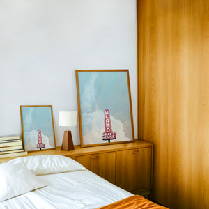 Alamo Drafthouse Austin Art print by Betsy Crum — framed in a wood-accent room