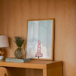 Alamo Drafthouse Austin Art print by Betsy Crum — framed in a wood-accent room
