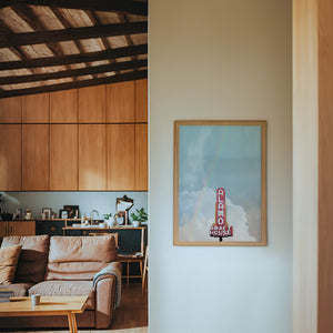 Alamo Drafthouse Austin Art print by Betsy Crum — framed in a wood-accent room