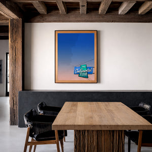 Continental Club sign print by Betsy Crum framed in a rustic room with wood beams