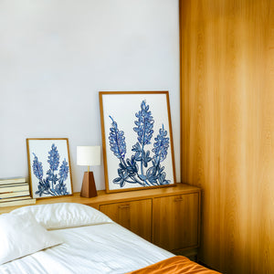 Chinoiserie Line bluebonnet art print by Betsy Crum — framed in a wood-accent room