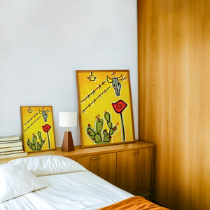 Dairy Queen Prickly Pear & Cow Skull cactus art print by Betsy Crum — framed in a wood-accent room