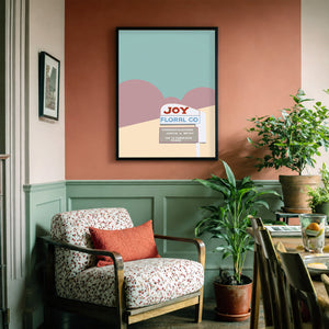 Fort Worth wall art Joy Floral neon sign print by Betsy Crum in a soft corner reading nook