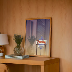 Randy's Bingo San Antonio art print by Betsy Crum — framed in a wood-accent room