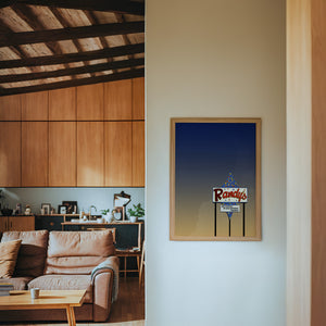 Randy's Bingo San Antonio art print by Betsy Crum — framed in a wood-accent room