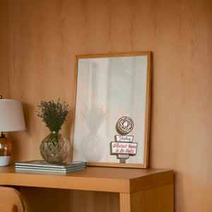 Shipley Do-Nuts Houston art print by Betsy Crum — framed in a wood-accent room