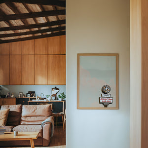 Shipley Do-Nuts Houston art print by Betsy Crum — framed in a wood-accent room