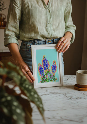 Blue Hill Country bluebonnet art print by Betsy Crum — neutral frame room mockup