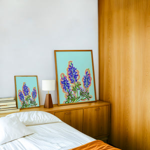 Blue Hill Country bluebonnet art print by Betsy Crum — framed in a wood-accent room