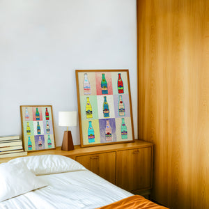 Warhol Pop Art Grid Topo Chico art print by Betsy Crum — framed in a wood-accent room