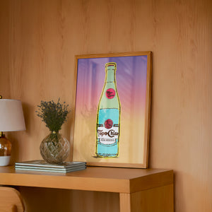West Texas Sunset Topo Chico art print by Betsy Crum — framed in a wood-accent room