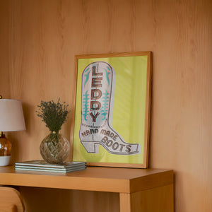 Leddy boot green wall art by Betsy Crum hung in a midcentury living room