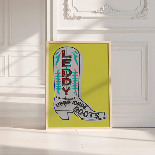 Green and grey Leddy boot art print by Betsy Crum in a wood frame in a calm white room