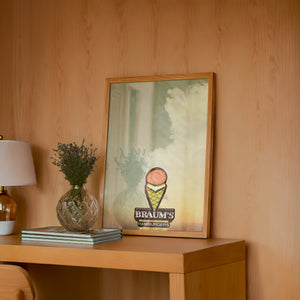 Braum's Sign Big Sky Americana art print by Betsy Crum — framed in a wood-accent room