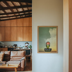 Braum's Sign Big Sky Americana art print by Betsy Crum — framed in a wood-accent room