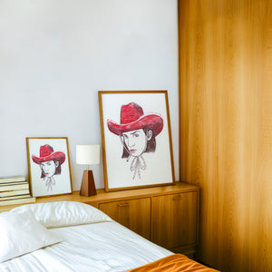 Pen & Ink Self Portrait cowgirl art print by Caya Crum — framed in a wood-accent room