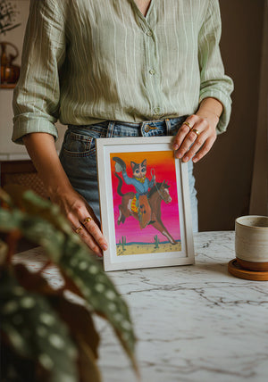 Cat Cowboy Bronco cat art print by Caya Crum — neutral frame room mockup