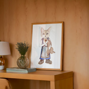 Frankie Fish Cat art print by Caya Crum — framed in a wood-accent room