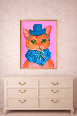Abbie yellow tabby cat print by Caya Crum framed above a dresser