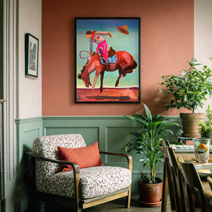 Cowgirl Bronc Rider, Hat Flying by Caya Crum, framed on a wall