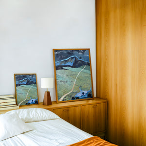 New Mexico Mountain and Field landscape print by Caya Crum — framed in a wood-accent room
