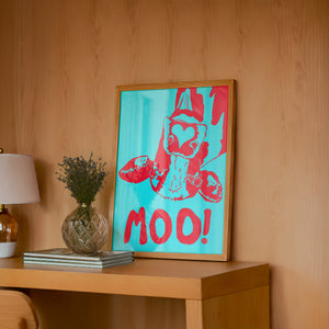 The Judy's Moo Cassette (blue and red) music wall art print by Betsy Crum — framed in a wood-accent room