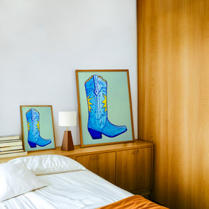 Fort Worth Boot Blue cowboy boot art print by Caya Crum — framed in a wood-accent room