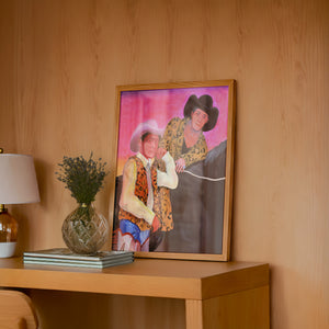 The Cowboy Gaze cowboy art print by Caya Crum — framed in a wood-accent room