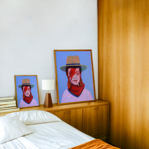 Cowboy Bowie music wall art print by Caya Crum — framed in a wood-accent room