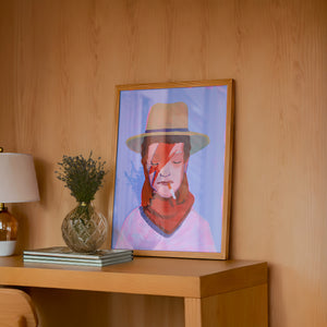 Cowboy Bowie music wall art print by Caya Crum — framed in a wood-accent room