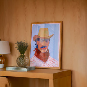 Wade cowboy art print by Caya Crum — framed in a wood-accent room