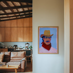 Wade cowboy art print by Caya Crum — framed in a wood-accent room