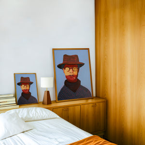 Clyde cowboy art print by Caya Crum — framed in a wood-accent room