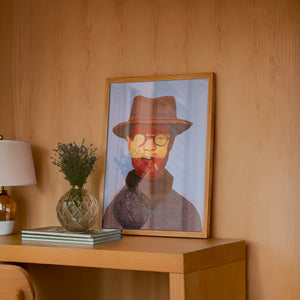 Clyde cowboy art print by Caya Crum — framed in a wood-accent room