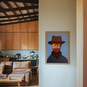 Clyde cowboy art print by Caya Crum — framed in a wood-accent room