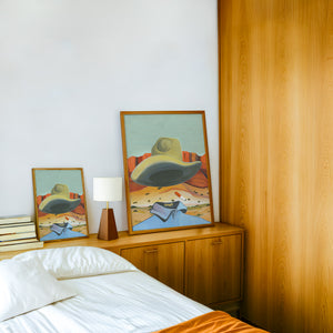 Ghost Cowboy cowboy art print by Caya Crum — framed in a wood-accent room