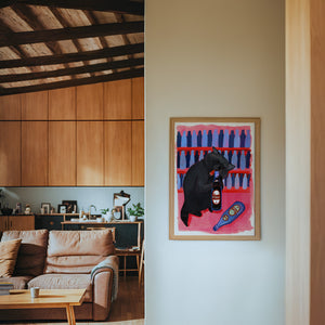Neon Raccoon Dr Pepper art print by Caya Crum — framed in a wood-accent room