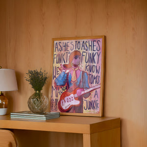 Bowie Ashes to Ashes music wall art print by Caya Crum — framed in a wood-accent room