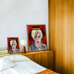 Cowboy Bowie music wall art print by Caya Crum — framed in a wood-accent room