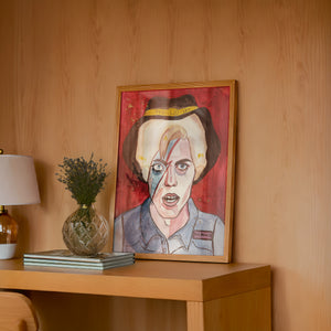 Cowboy Bowie music wall art print by Caya Crum — framed in a wood-accent room