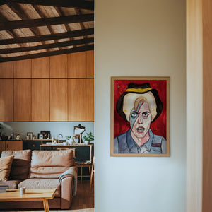 Cowboy Bowie music wall art print by Caya Crum — framed in a wood-accent room