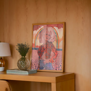 Dolly Parton Rainbow music wall art print by Caya Crum — framed in a wood-accent room
