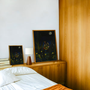 Fire Flies Cowboy at Night western art print by Caya Crum — framed in a wood-accent room